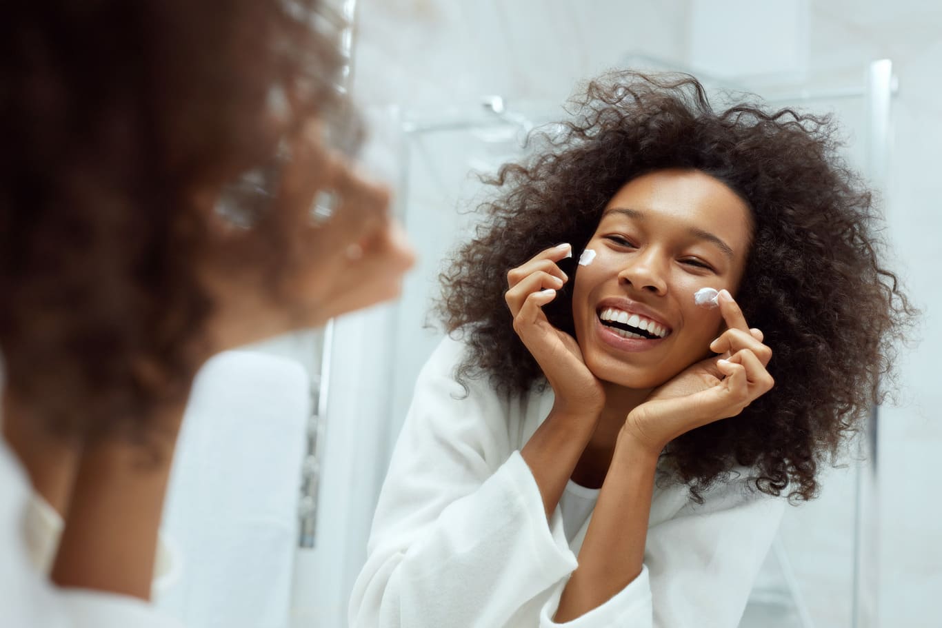 Woman laughing in front of the mirror