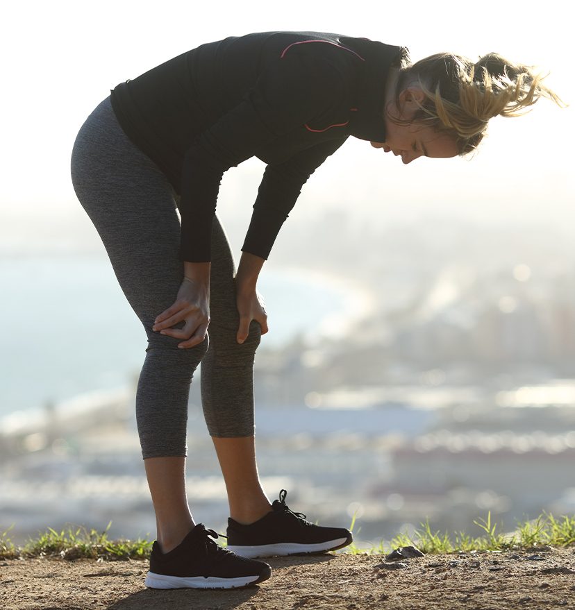 Photo of a woman on a jog, stopping to take a breather