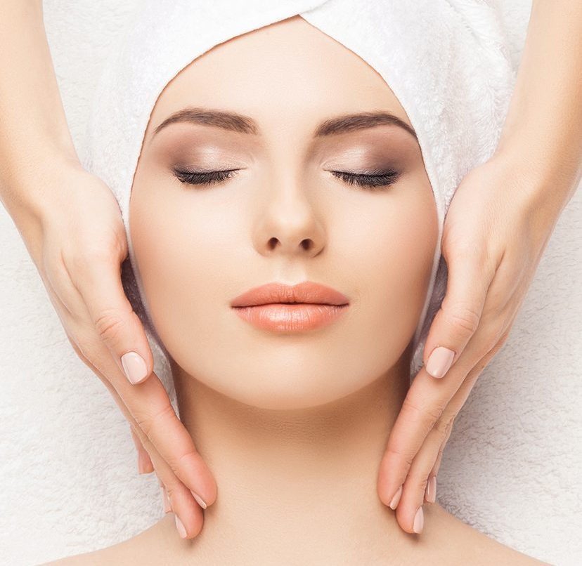 Photo of a woman at a spa getting a facial massage