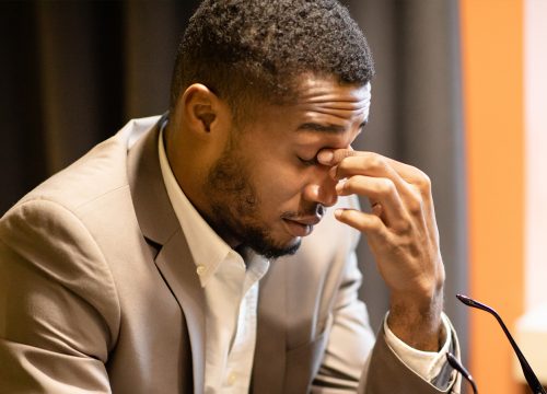 Photo of a man at a desk job fighting off fatigue