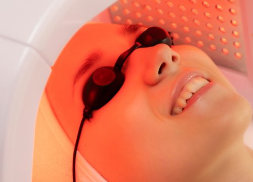 Photo of a woman receiving LED light therapy treatments