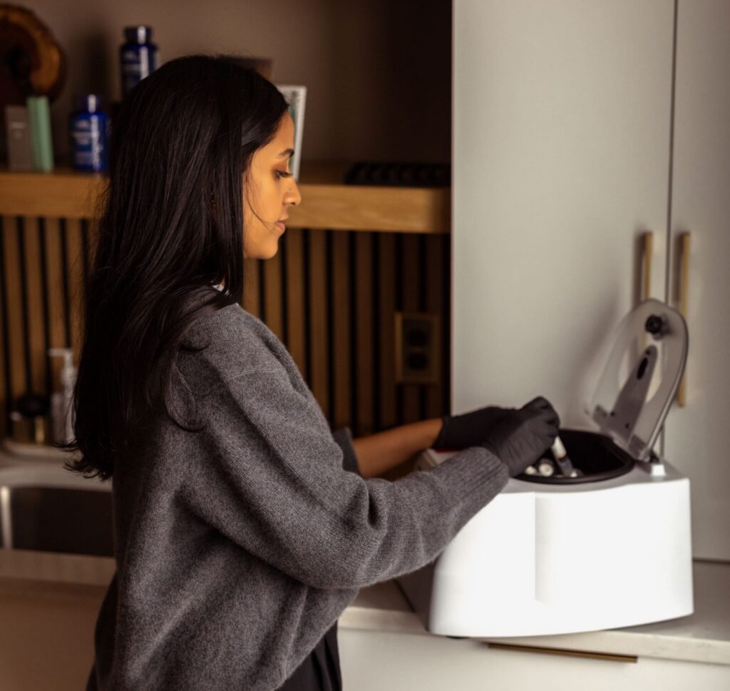 Photo of Srisha using a centrifuge