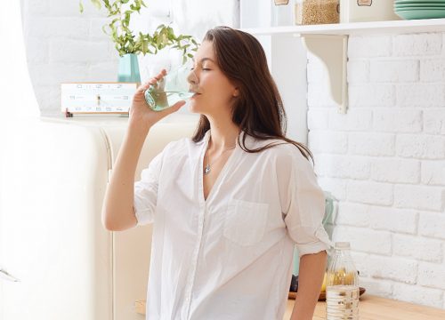 Woman drinking a glass of water.