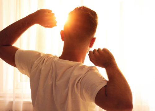 Man waking up energized after NAD+ IV therapy